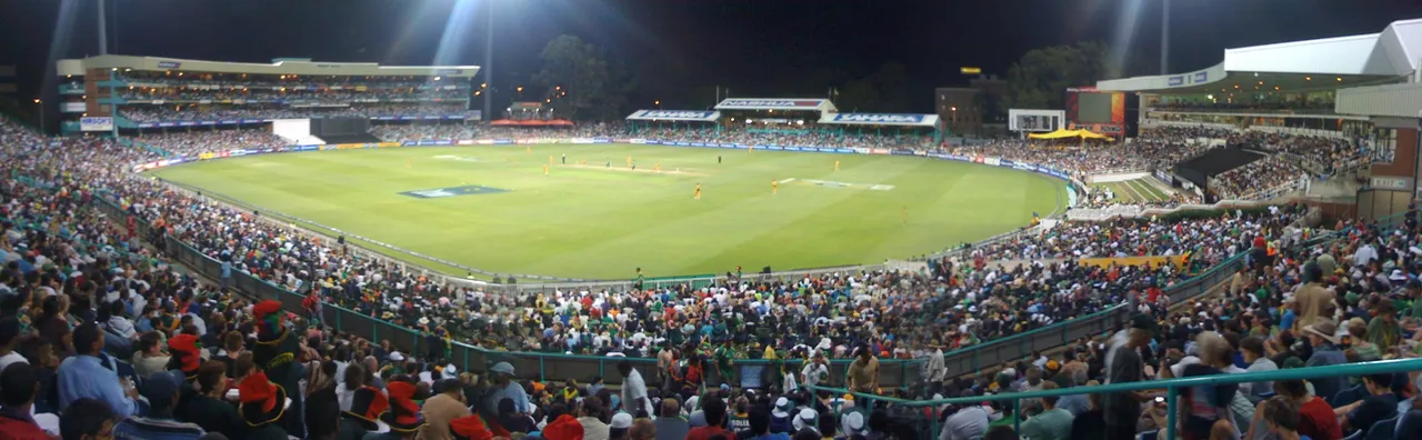 Kingsmead cricket ground under floodlights, surrounded by spectators during a night match in 2009.
